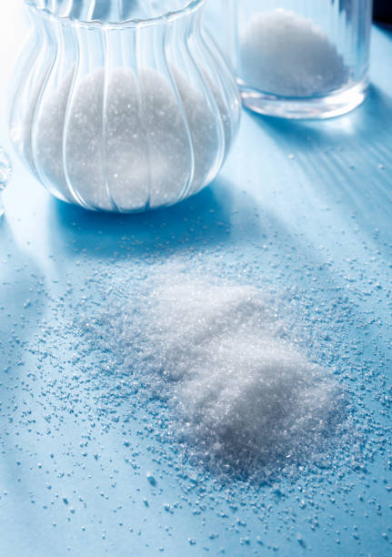 istock Sugar and glassware with white sugar, on a blue background 802337436