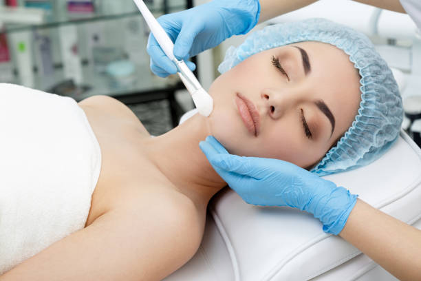 istock Doctor touching patient's face with brush 802348766