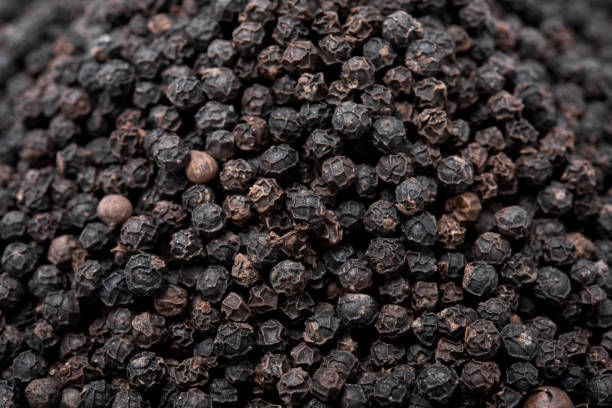 istock closeup the dried black peppers as background 802352448