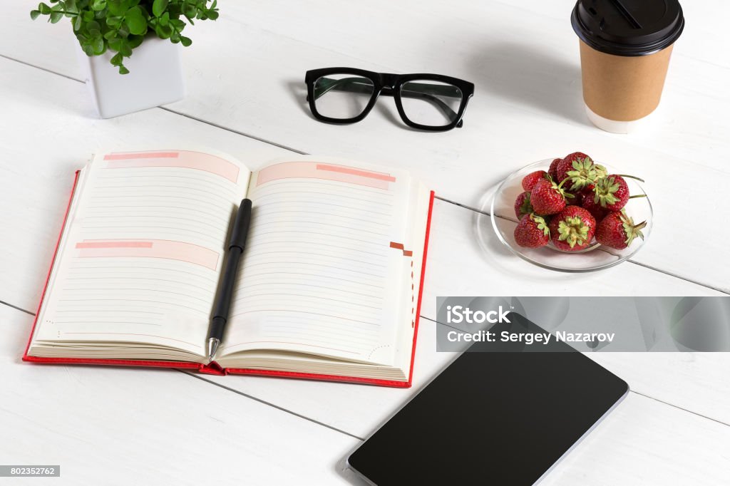 Stylish minimalistic workplace with tablet and notebook and glasses in flat lay style. White background Stylish minimalistic workplace with tablet and notebook and glasses in flat lay style. White background. Top view. Copy space Adult Stock Photo