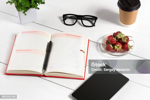 Stylish Minimalistic Workplace With Tablet And Notebook And Glasses In Flat Lay Style White Background Stock Photo - Download Image Now