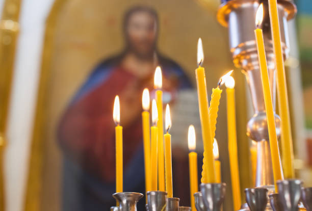 Church candles burn in the church Church candles burn in the church against the background of the icon of Jesus Christ. worshipper photos stock pictures, royalty-free photos & images