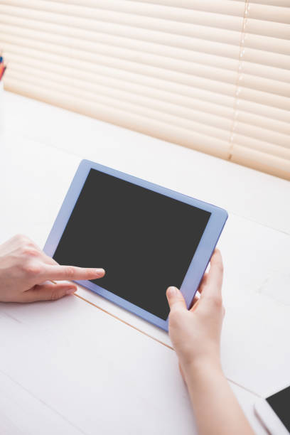 istock Close up view of businesswoman using her tablet 802367220
