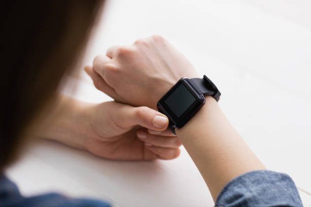 istock Casual businesswoman using her smart watch 802372146