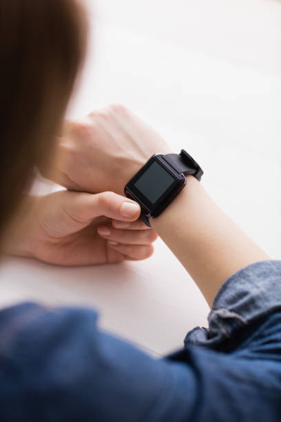 istock Casual businesswoman using her smart watch 802373582