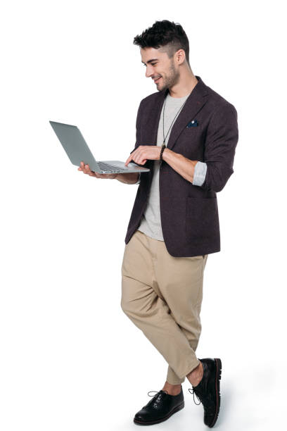 istock Brunet man in casual clothes typing laptop isolated on white 802378220