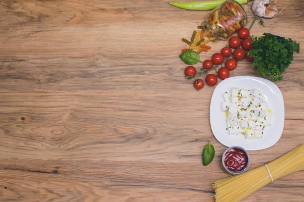 Italian pasta ingredients on wooden table, top view