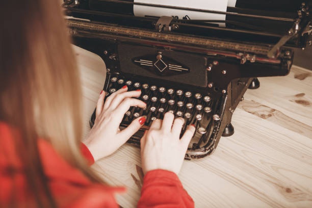 istock Secretary at old typewriter with telephone. Young woman using typewriter. Business concepts. 802382176