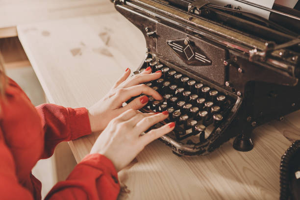 istock Secretary at old typewriter with telephone. Young woman using typewriter. Business concepts. 802382192