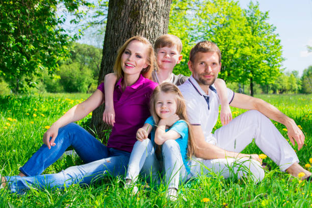 istock Family on grass in summer park 802386960