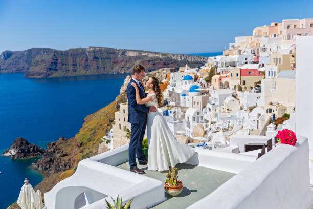 Wedding couple  on  Santorini Wedding couple  on the background architecture of Santorini happy couple on vacation in santorini greece stock pictures, royalty-free photos & images