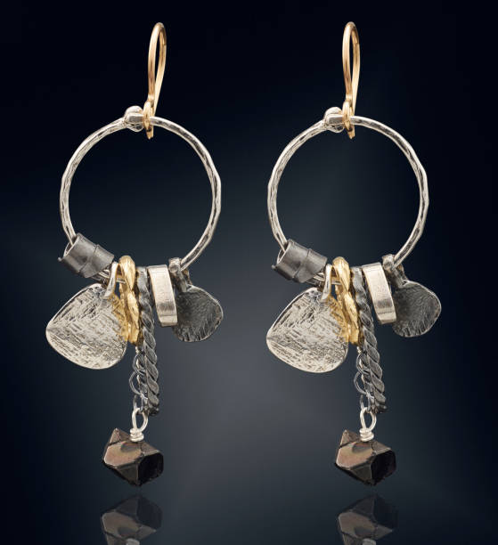 istock Golden earrings  isolated on black background 802413926