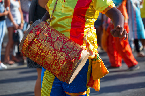 Percussionist playing with a dhol during the carnival of the Grand Boucan.