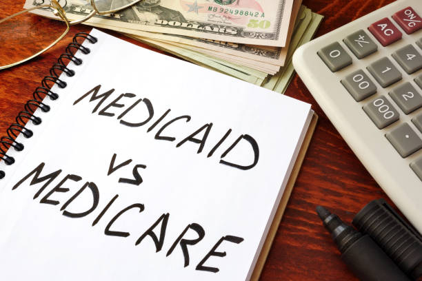istock Medicaid vs Medicare written in a note. Health insurance concept. 802417288