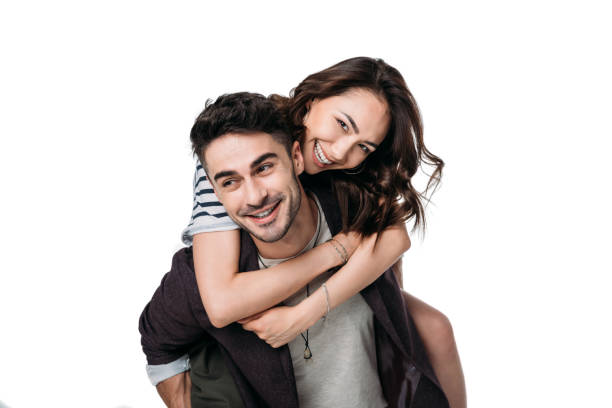 istock young smiling couple doing piggyback isolated on white 802428176