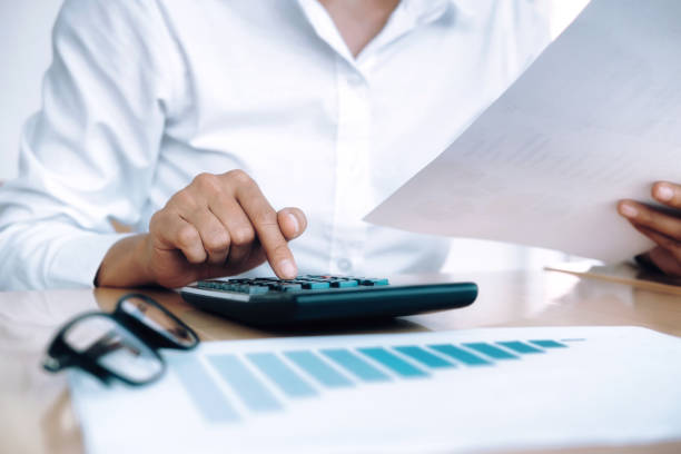 istock Finances Saving Economy concept. Female accountant or banker use calculator. 802428566