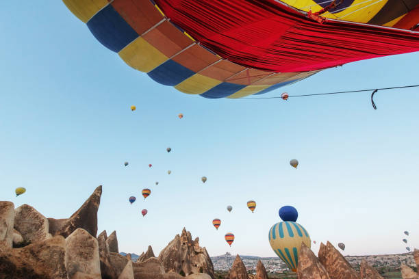istock Hot air balloon flying over rock landscape at Turkey. Cappadocia 802428882