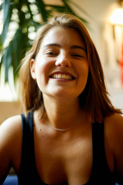 istock Young woman smiling at camera, portrait 802429184