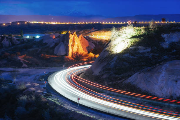istock Night road in the mountains, the lights from the headlights 802431864