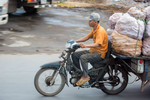 A local transports goods with a motorcycle during the morning commute in Ho Chi Minh City (Saigon).