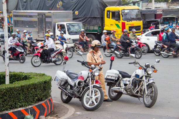 A traffic cop by his motorcycle during the morning commute in Ho Chi Minh City (Saigon).