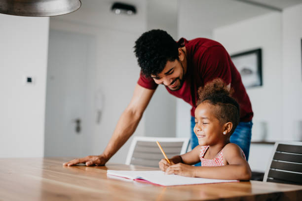 istock Father doing homework with his preschool daughter 802436538