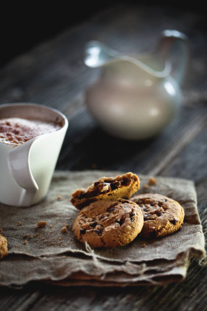istock Chocolate chip cookies and cup of coffee on wooden table. 802440308