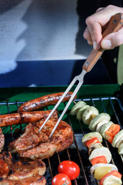 istock cropped shot of human hand pricking roasted steak with barbecue fork 802440510