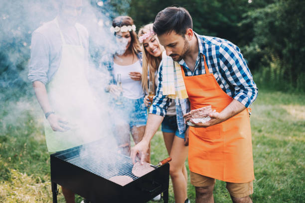 istock Friends spending time in nature and having barbecue 802443512