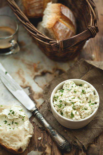istock Bread buns with young cheese and espresso on wooden table. 802444000