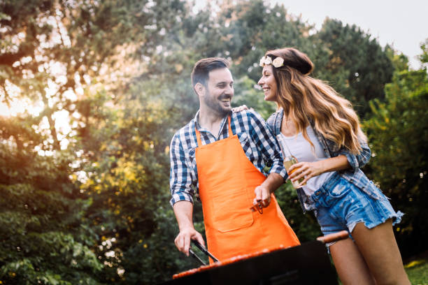 istock Beautiful woman and handsome man having barbecue 802446498