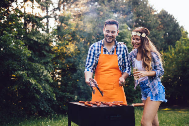 istock Beautiful woman and handsome man having barbecue 802446540