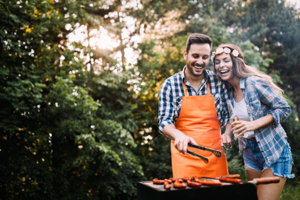 istock Beautiful woman and handsome man having barbecue 802448620