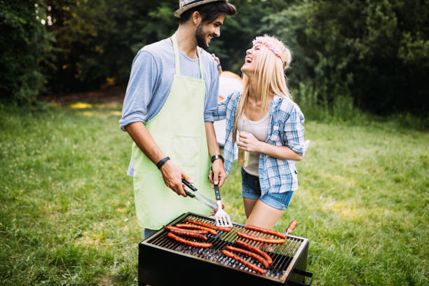 istock Beautiful woman and handsome man having barbecue 802448740