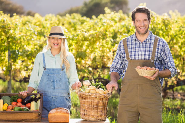 istock Happy farmer couple presenting their local food 802448758