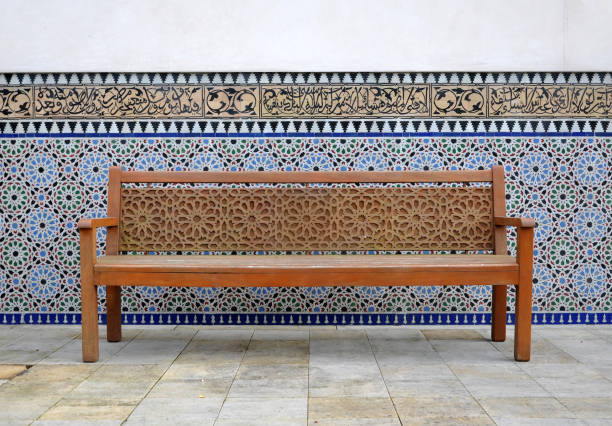 Wooden park bench with beautiful patterns in the East garden. Gardens of the world in Berlin.