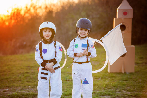 istock Two adorable children, playing in park on sunset 802452330