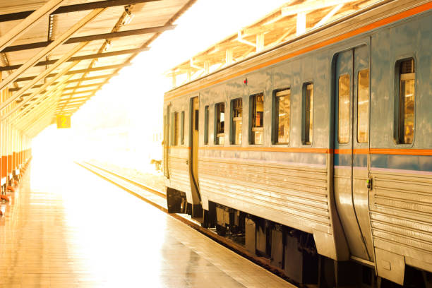 istock train stop at railway station with sunset 802452514