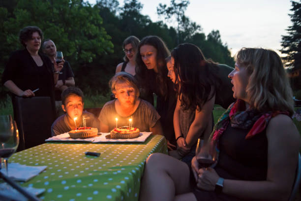 istock Big dinner: grandmother celebrating birthday outdoors at dusk. 802458698