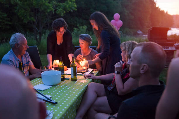istock Big dinner: grandmother celebrating birthday outdoors at dusk. 802458884