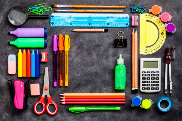 istock Top view of school or office supplies with copy space on blackboard background 802465052