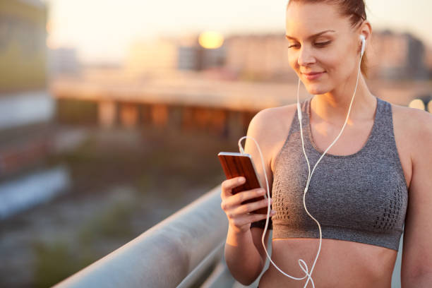 istock Woman listening music after running 802468462
