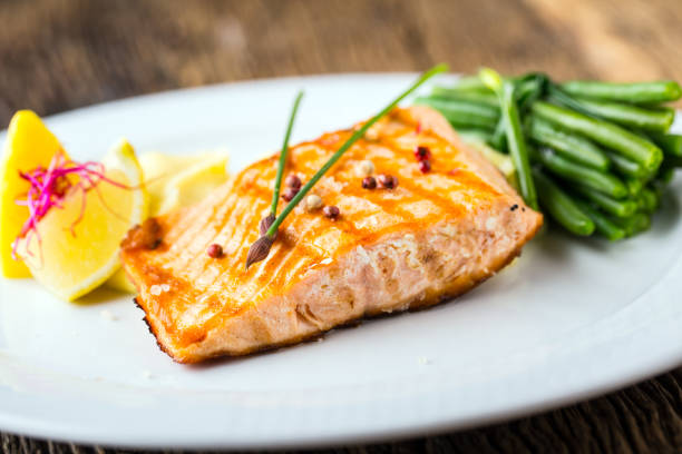 istock Grilled Salmon. Salmon fillet with lemon and green beans. Grilled fish 802468730