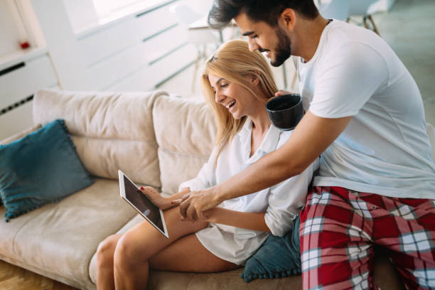 istock Young attractive couple spending time together at home 802469630