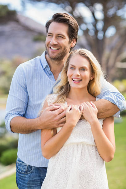 istock Cute couple on date with arms around 802471874