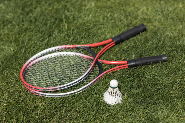 istock close up of badminton rackets with shuttlecock on grass 802471960