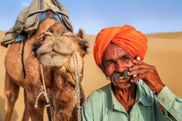 istock Indian man using a mobile, desert village, India 802472550