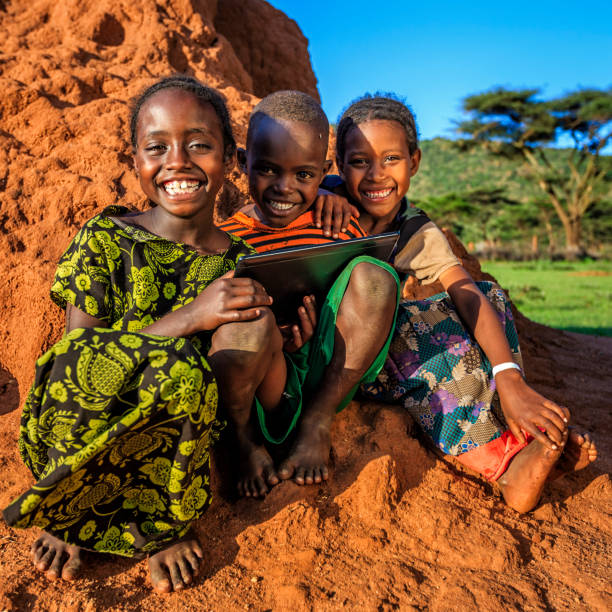 istock Little African children using digital tablet, East Africa 802476130