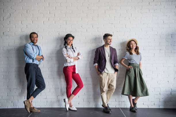 istock young multiethnic friends posing in stylish clothes near brick wall 802477274