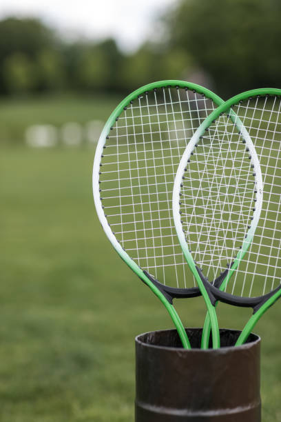 istock Close-up view of two badminton racquets in container outdoors 802477438